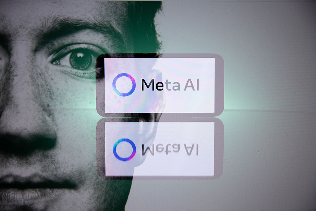 Mark Zuckerberg and a telephone displaying the Meta group artificial intelligence logo