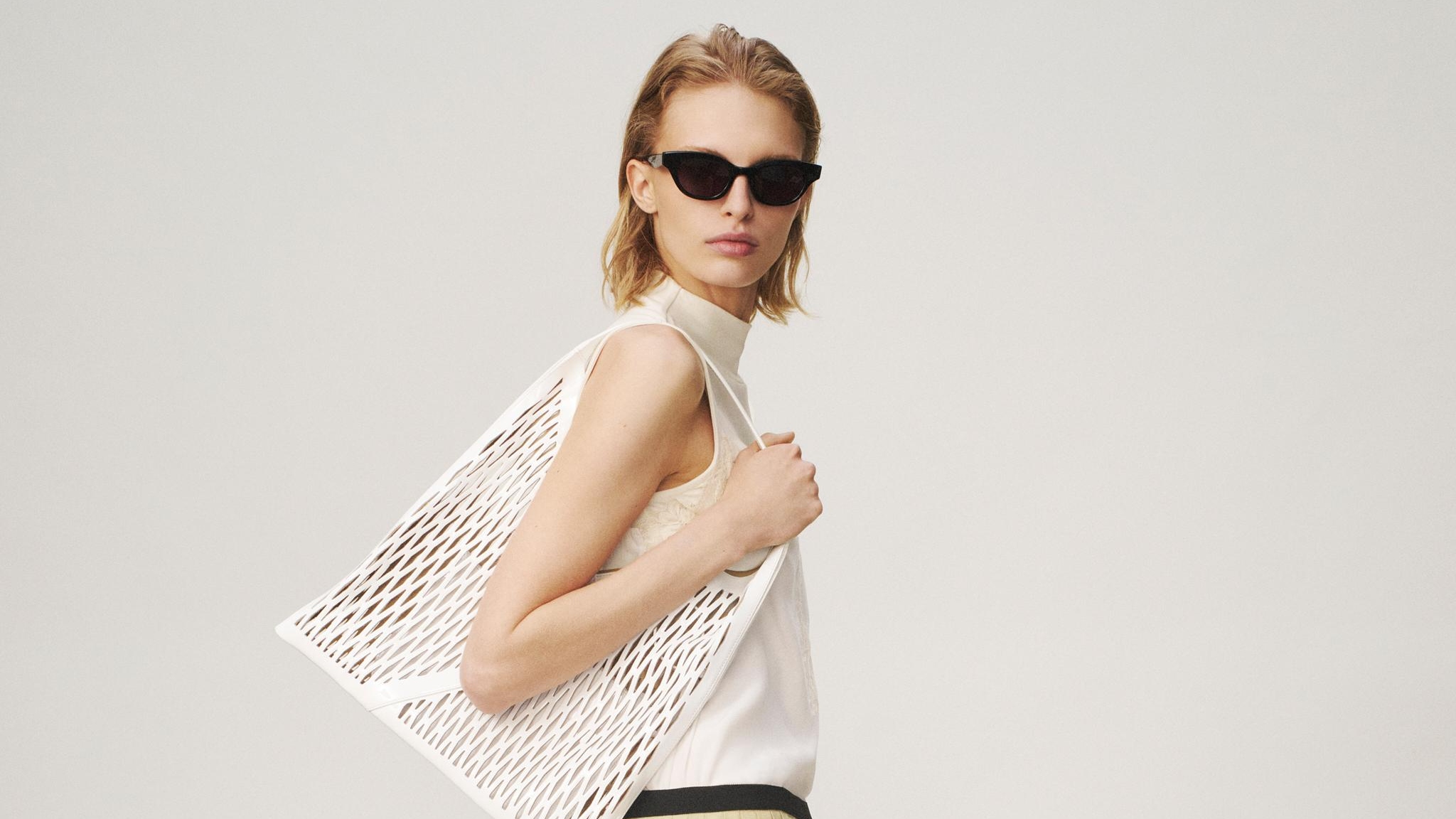woman holding woven bag