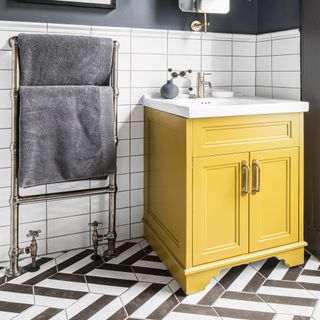 Monochrome bathroom with tiels walls and floor and yellow vanity unit