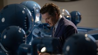 Pedro Pascal's Reed Richards surrounded byy spacesuit helmets in his lab in The Fantastic Four: First Steps