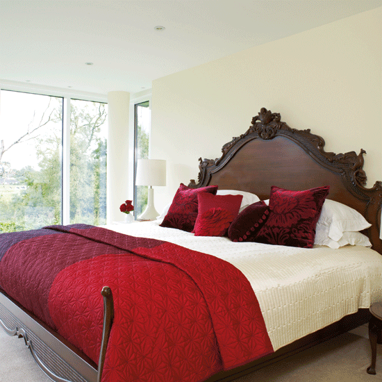 bedroom with wooden headboard and ceiling windows