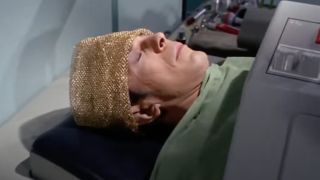 Spock sitting in a device after his brain was stolen