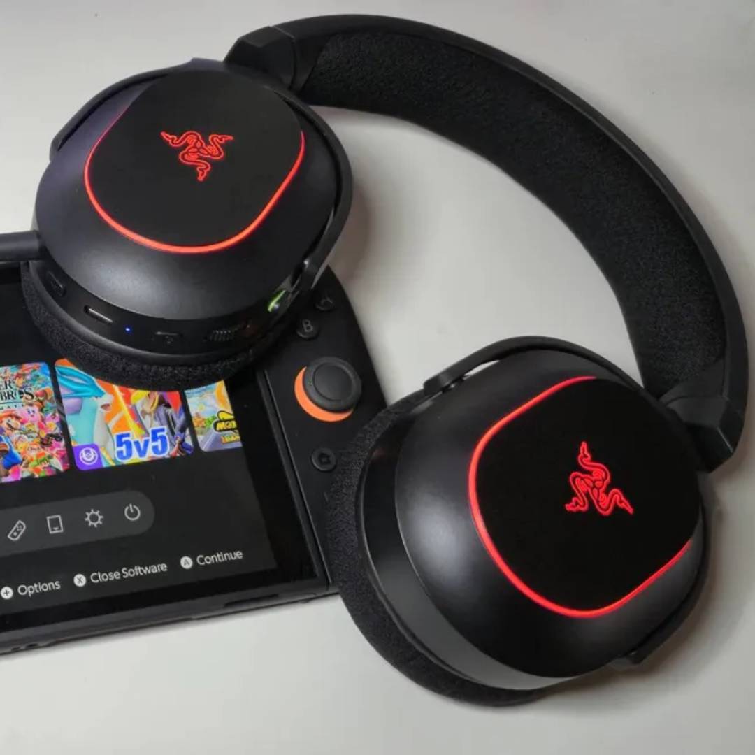Razer Barracuda X Chroma headset lying on top of Switch 2 on white desk