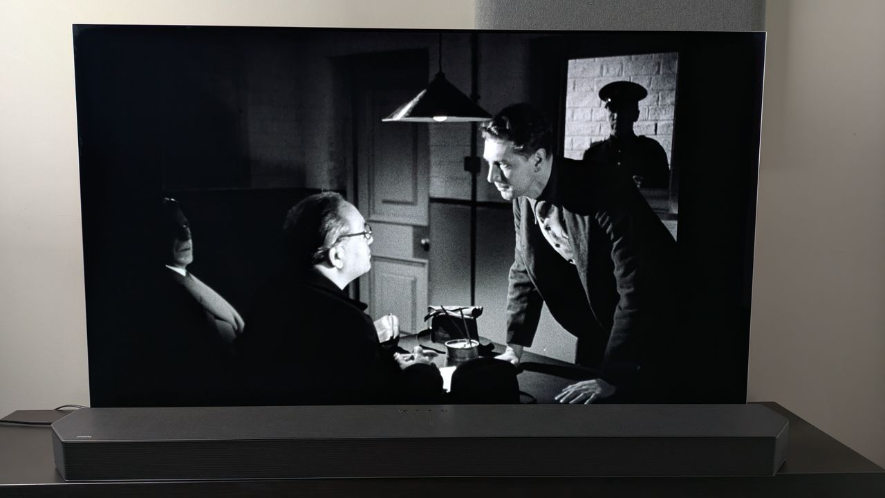 A shot of two men in a dimmed room from the Dead of Night (1945) 4K Blu-ray on the LG G5 screen