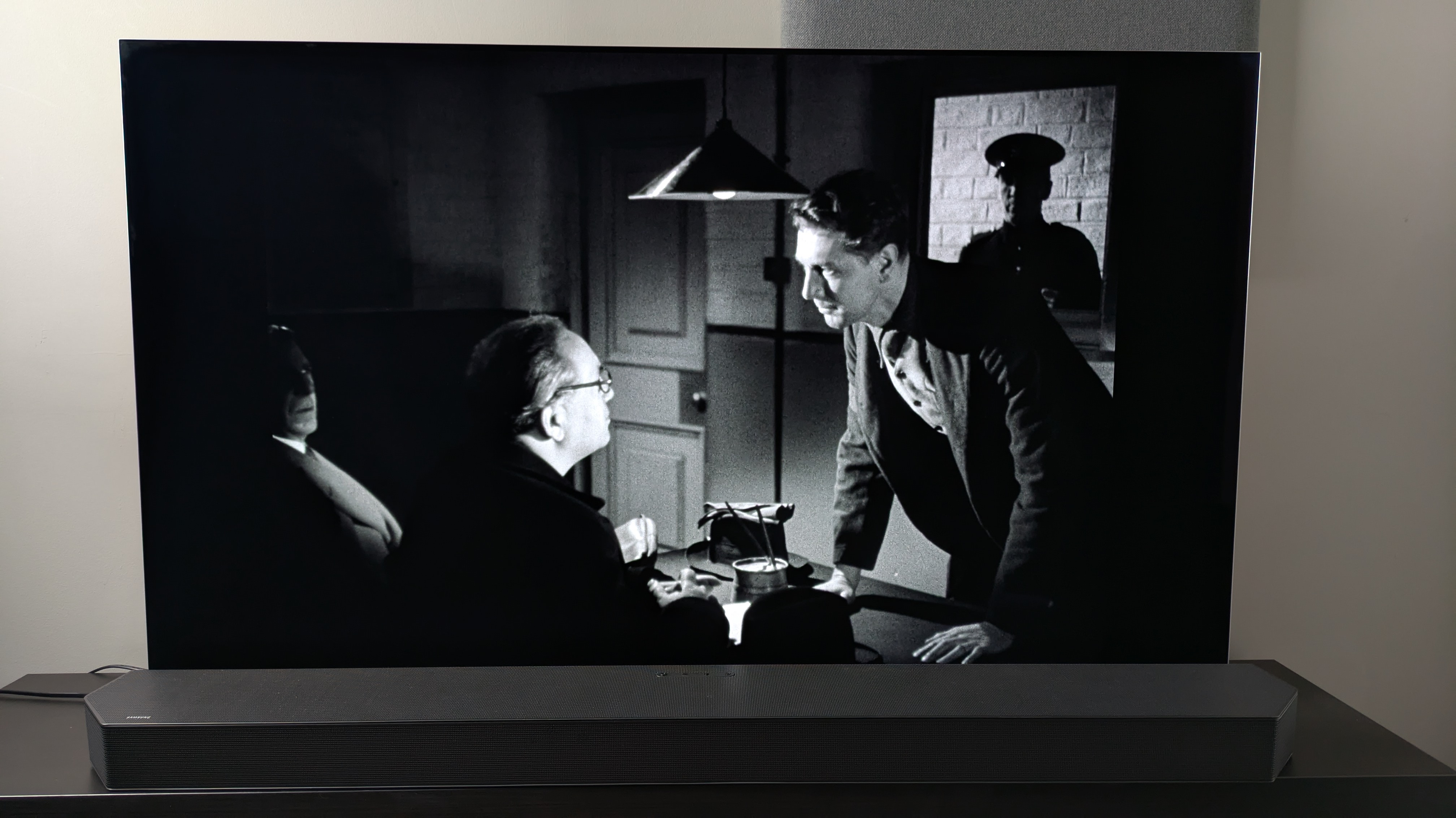 A shot of two men in a dimmed room from the Dead of Night (1945) 4K Blu-ray on the LG G5 screen