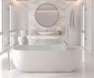 A luxury white bathtub in a white marble bathroom