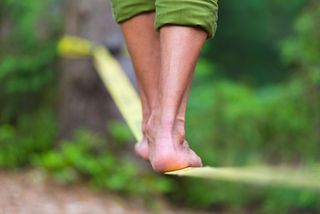 A person balances on a rope