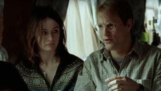 Emily Mortimer and Woody Harrelson speaking to a fellow train passenger in Transsiberian