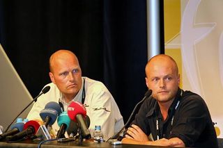 Bjarne Riis (L) sits alongside team spokesperson Brian Nygaard.