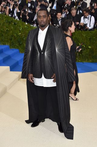 Diddy wearing a modern twist on a dinner jacket with the pinstripes fanning out from one point.