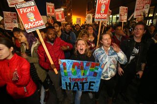 Emma Esselstyn (center), a student at the University of Washington joins thousands of protesters march down 2nd Avenue on November 9, 2016 in Seattle, Washington. Demostrations in multiple cities around the country were held the day following Donald Trump