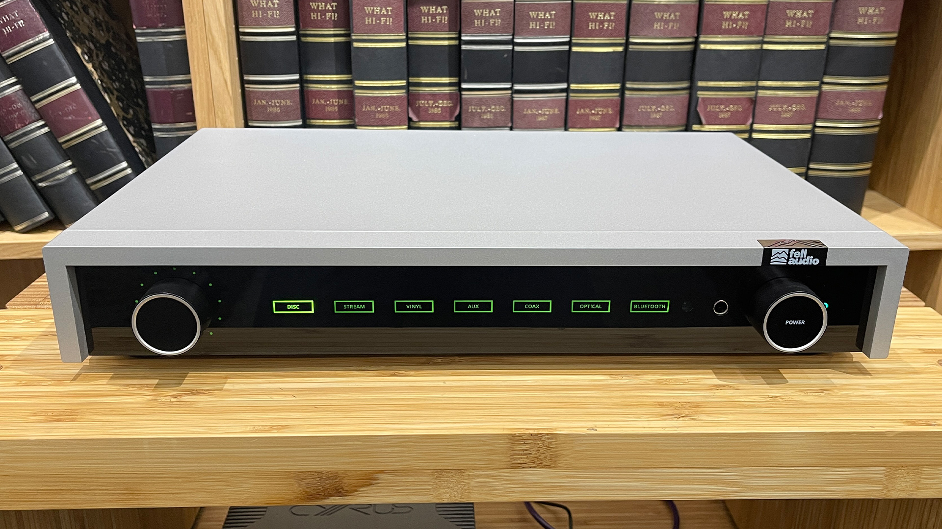 Fell Audio Fell Amp integrated amplifier on wooden hi-fi rack in front of bookcase