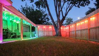 A picture of a back yard adorned with Govee's outdoor string lights and a neon rope light