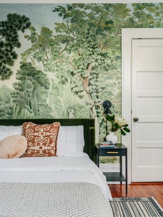 A small bedroom with a larger-than-life wallpaper