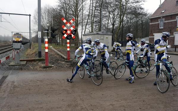 Vacansoleil-DCM riders stop for a train while previewing the Omloop Het Nieuwsblad route.