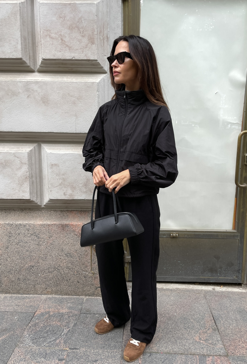 An image of @johannapiispa wearing cigarette trousers with a windbreaker jacket and suede trainers.