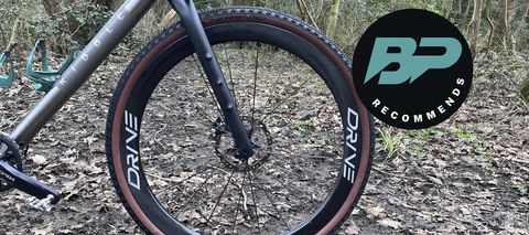 Bike wheel on bike with woods backdrop