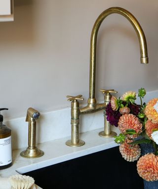 A gold kitchen sink with flowers inside
