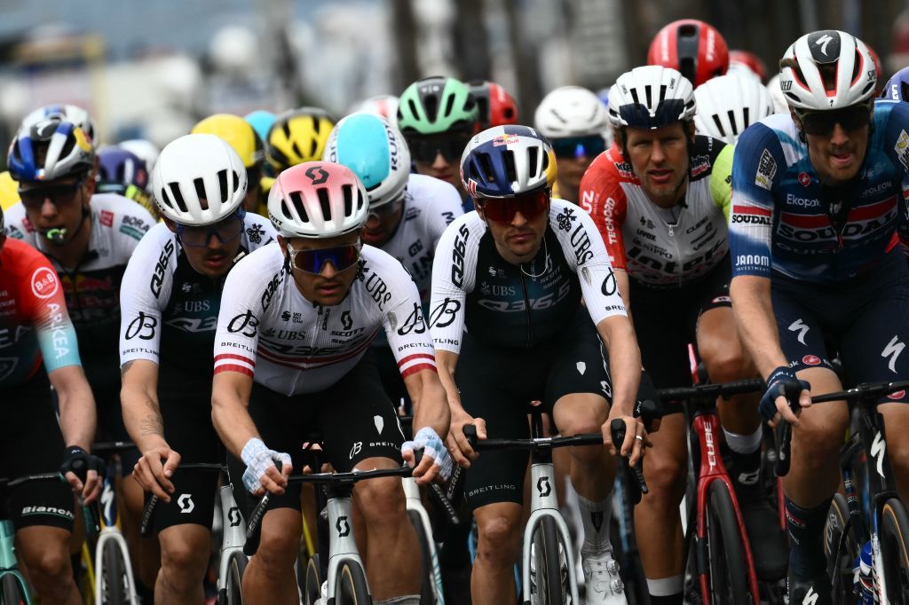 Team Q36.5's British rider Thomas Pidcock (C) rides in the pack during the Milan - Sanremo one-day classic cycling race, on March 22, 2025. (Photo by Marco BERTORELLO / AFP)