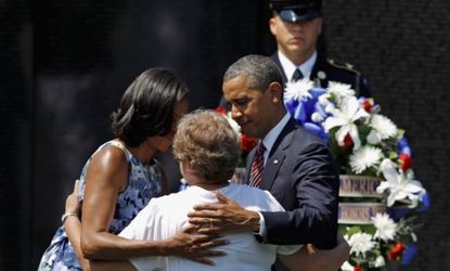 President Obama and the first lady embrace a woman who lost her husband in the Vietnam War during the first memorial event in the 13-year Vietnam 50th Anniversary Commemoration Program.