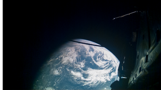 Earth is seen from space. Some of the spacecraft that took this image is visible in the frame as well.