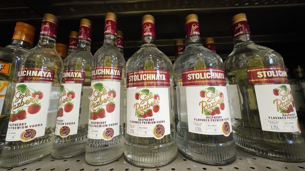 Bottles of Stolichnaya vodka on a shelf.