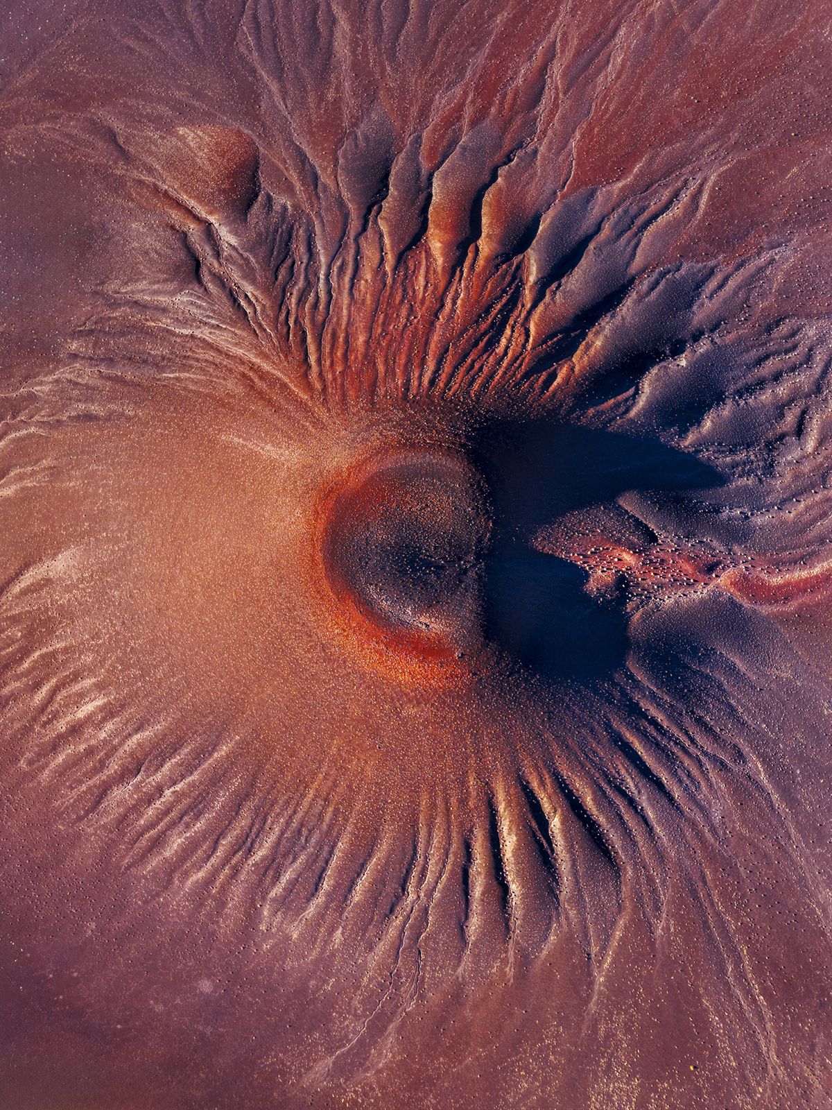A dormant volcano in the high-altitude Puna of Argentina reveals intricate erosion patterns sculpted by wind and time