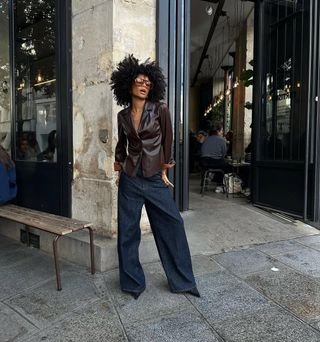 woman wearing baggy jeans and leather blazer