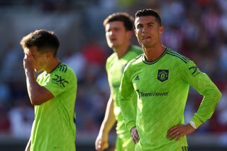 Cristiano Ronaldo and Lisandro Martinez of Manchester United look dejected during the Premier League match between Brentford FC and Manchester United at Brentford Community Stadium on August 13, 2022 in Brentford, England.