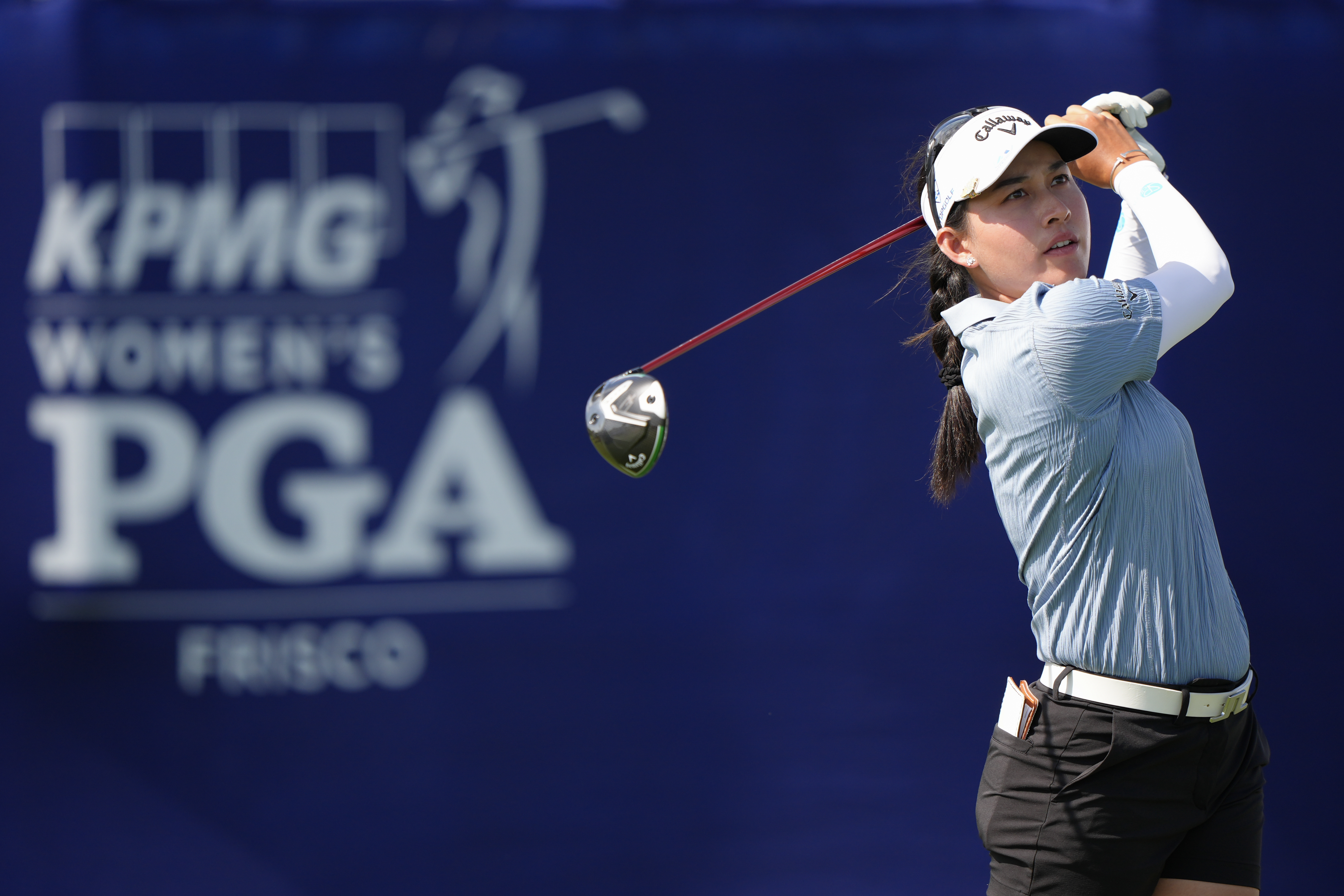 Jeeno Thitikul hits a driver in front of a sponsor board