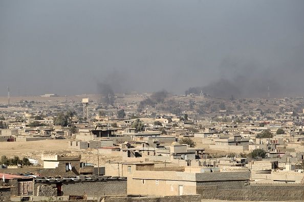 Smoke billows from buildings south of Mosul.