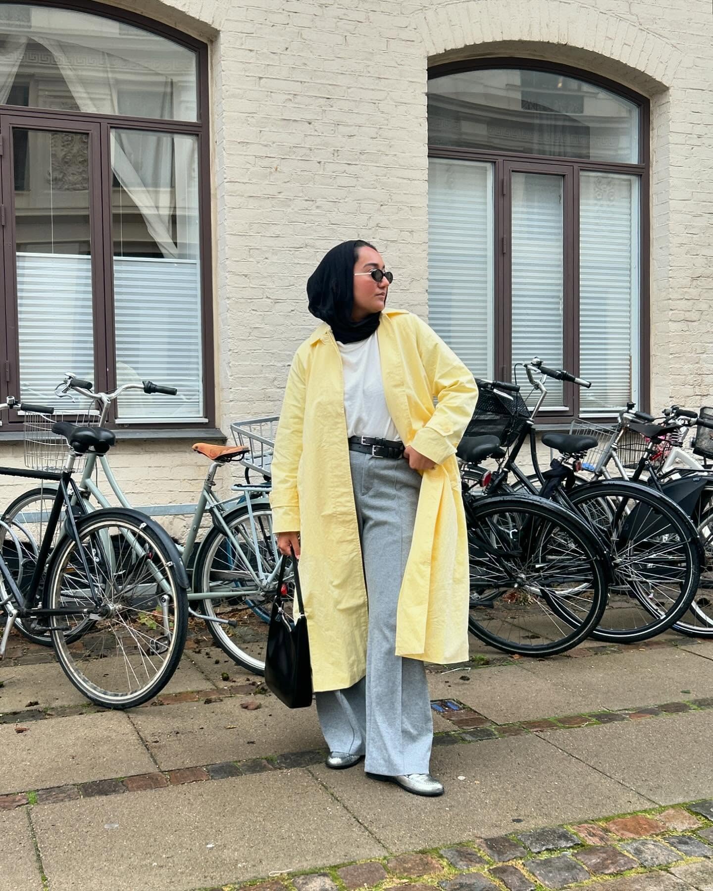 Yusra Siddiqui wearing a pastel yellow coat.