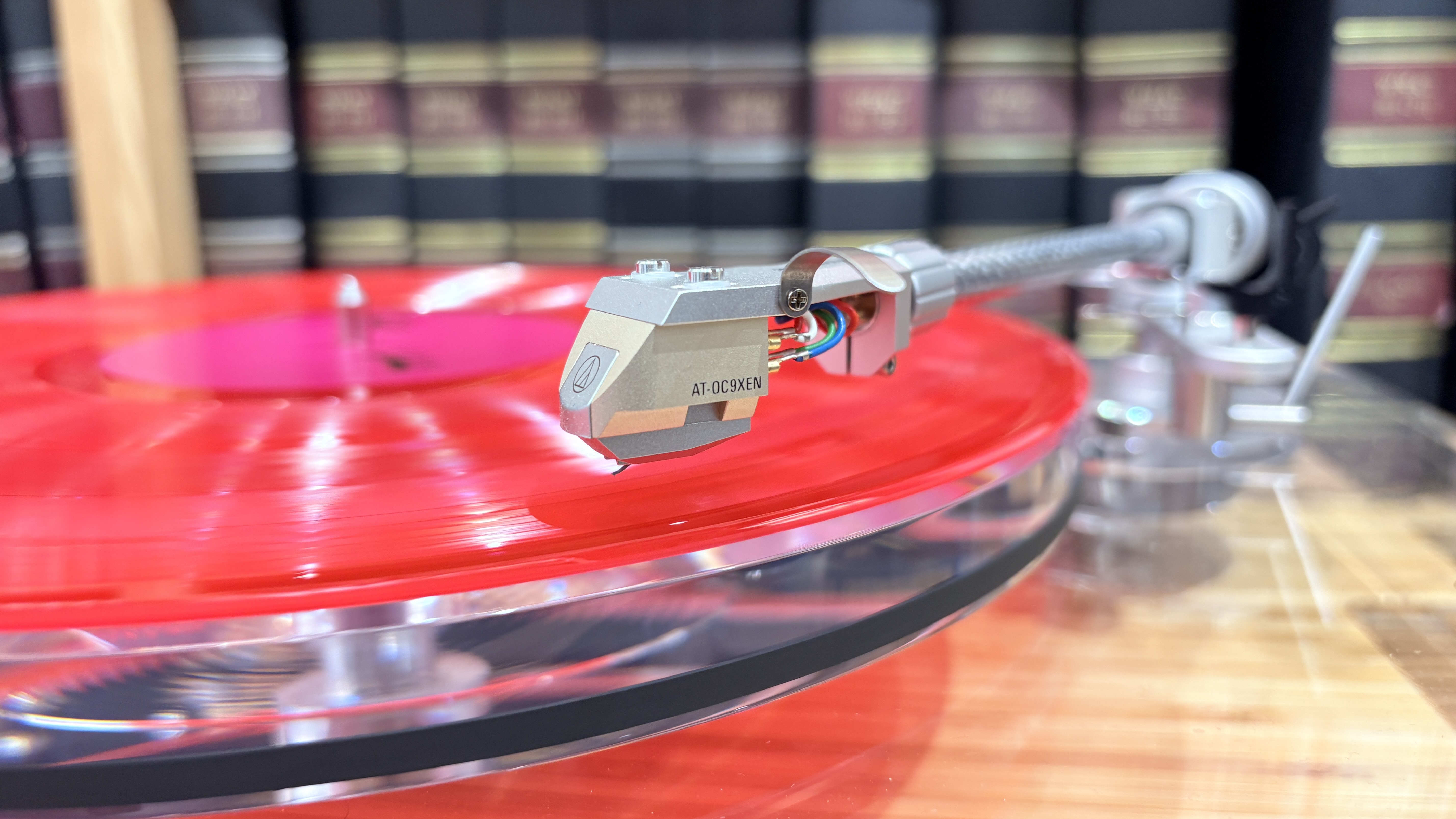 Audio-Technica AT-LPA2 turntable on wooden rack with books in background