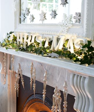 Mantelpiece with tinsel, Christmas letters and lights