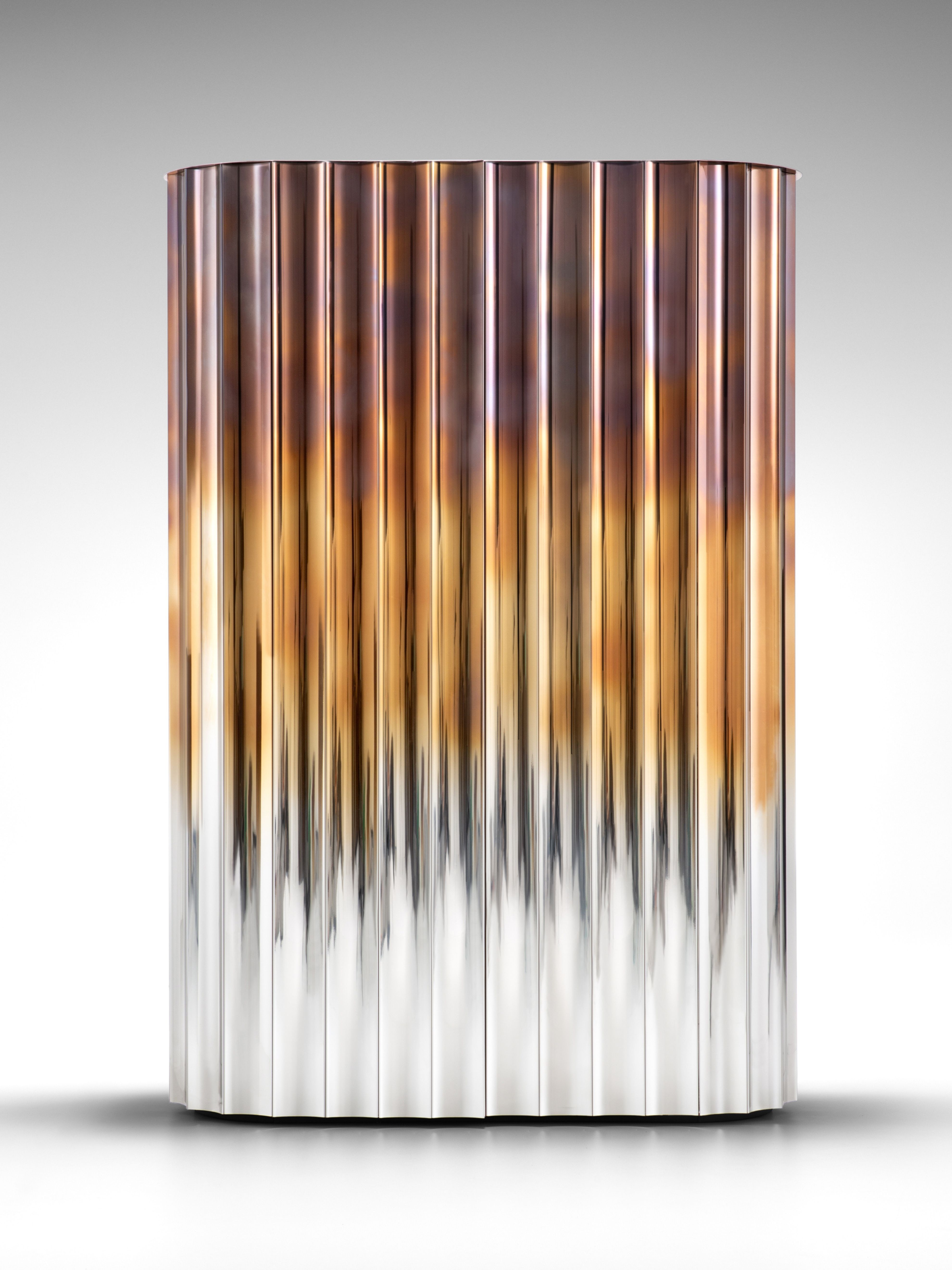 a chrome, gold and copper fluted cabinet closed