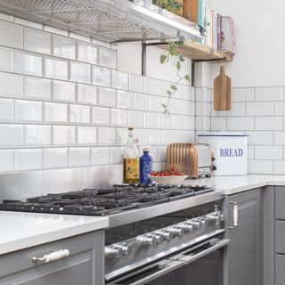 gas hob in grey kitchen with white subway tiles