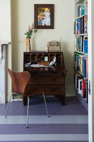Blue stripe painted floorboards with a bureau desk