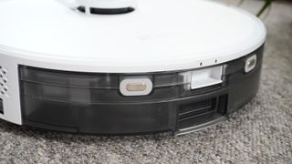 The EZVIZ RE4 Plus robot vacuum in a carpeted living room