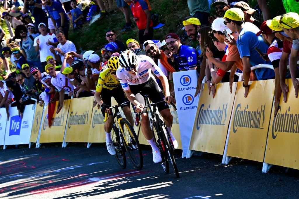 GRAND COLOMBIER FRANCE JULY 14 Tadej Pogacar of Slovenia and UAE Team Emirates White Best Young Rider Jersey R attacks to Jonas Vingegaard of Denmark and Team JumboVisma Yellow Leader Jersey in the final kilometres of the climb to the Grand Colombier 1501m while fans cheer dduring the stage thirteen of the 110th Tour de France 2023 a 1378km stage from ChtillonSurChalaronne to Grand Colombier 1501m UCIWT on July 14 2023 in Grand Colombier France Photo by Bernard Papon PoolGetty Images