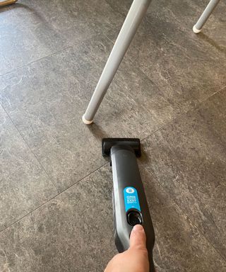 Shark Cordless Handheld Vacuum WV200UK on laminate flooring in kitchen by high chair