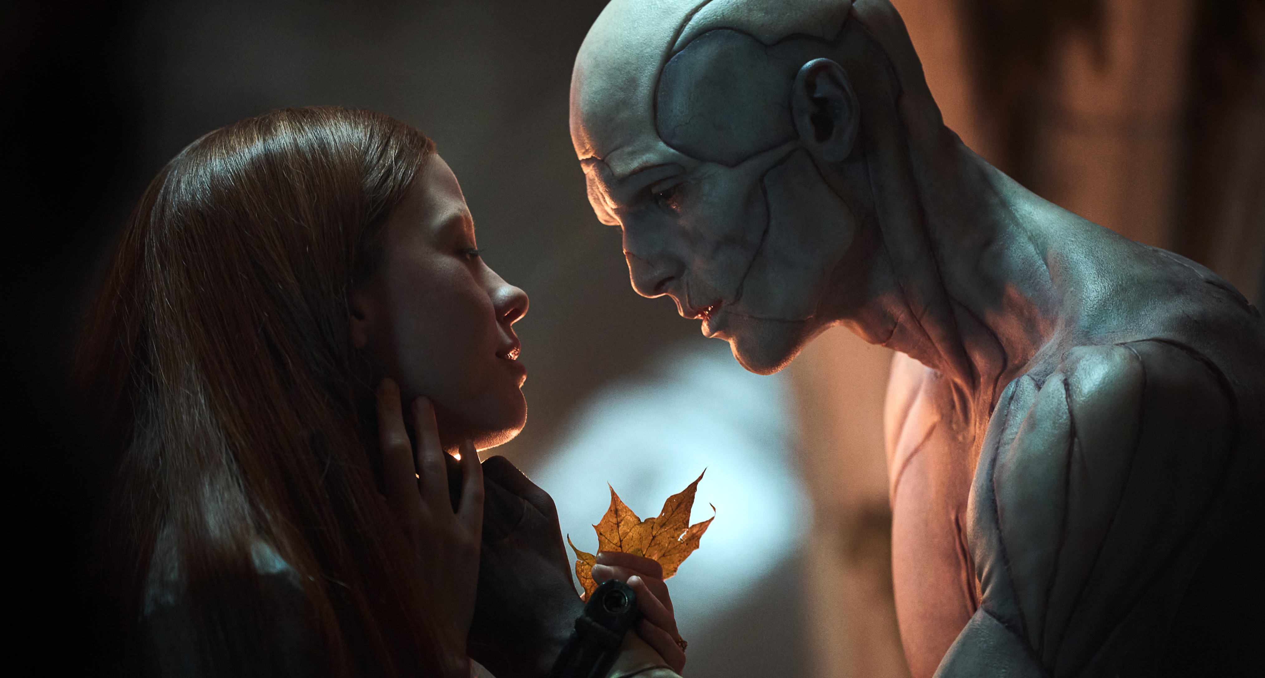 the creature caresses elizabeth&#039;s face while they examine a leaf in a still from frankenstein