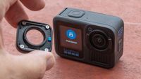 Adam Juniper putting lens cover onto GoPro 13 Hero Black which is sitting on red