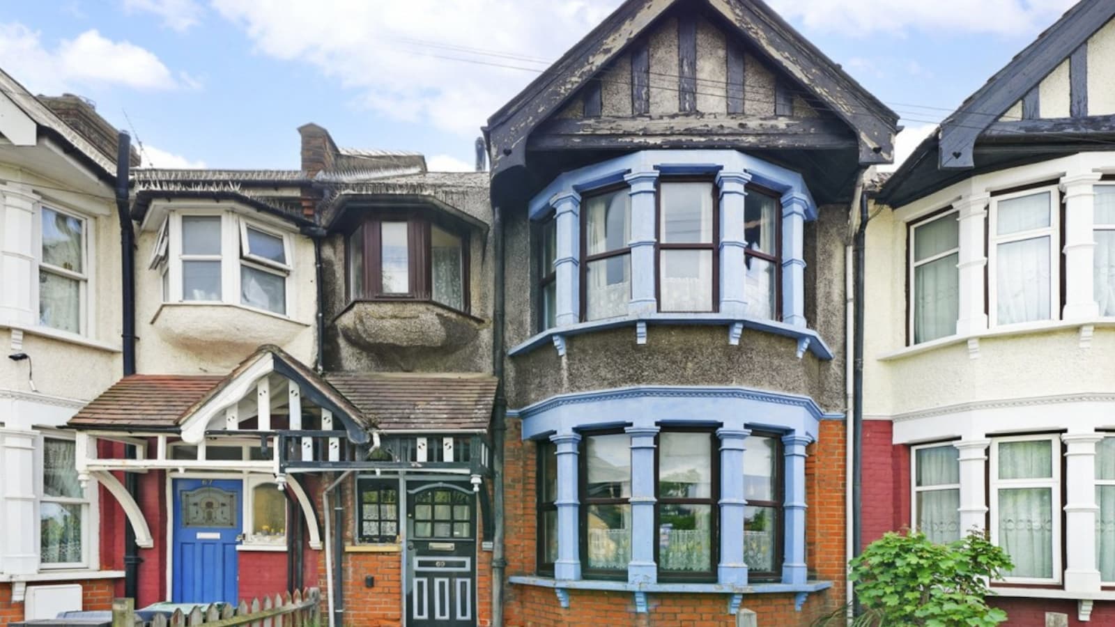 A period property with worn front and blue eaves