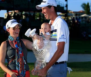 Chesson Hadley holds his son Hughes in the trophy