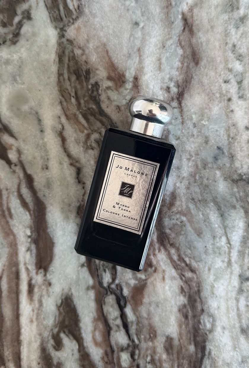 A photo of Jo Malone Myrhh & Tonka perfume on a marble table