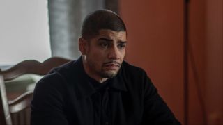 Reyes sitting at a table in Law & Order: Organized Crime Season 4x06