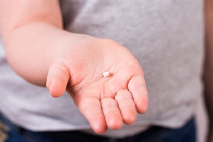 A baby tooth in a child's hand.