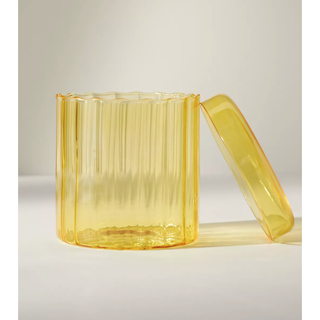 yellow glass jar with wavy rim and lid