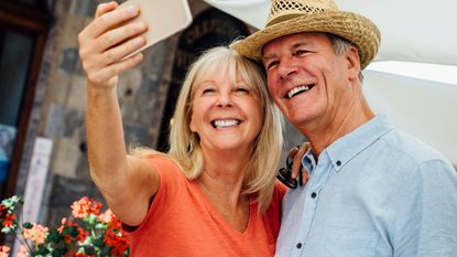 Senior couple taking a selfie at an outdoor market 