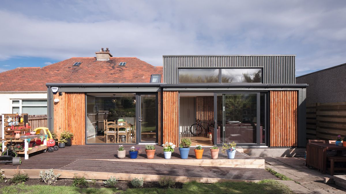 timber clad wrap around extension to bungalow with sliding patio doors